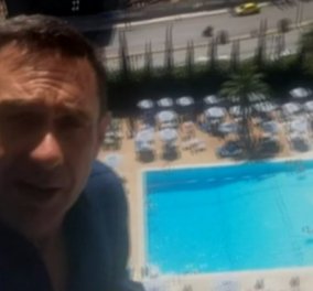 O δημοσιογράφος του Channel 4 σκαρφαλωμένος στο Hilton : «Πρωτοφανή πράγματα συμβαίνουν στην Αθήνα»