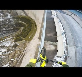 Ριψοκίνδυνος νεαρός οδηγεί το ποδήλατό του στην άκρη ενός φράγματος ύψους 200 μέτρων (βίντεο)