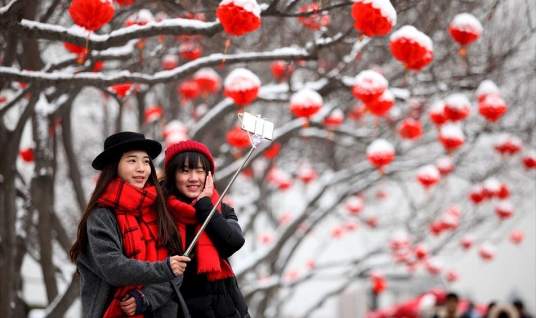 Τουρίστριες βγάζουν selfie μετά από σπάνια χιονόπτωση στην πόλη Σιάν στην Κίνα - Picture: REUTERS / CHINA STRINGER NETWORK 